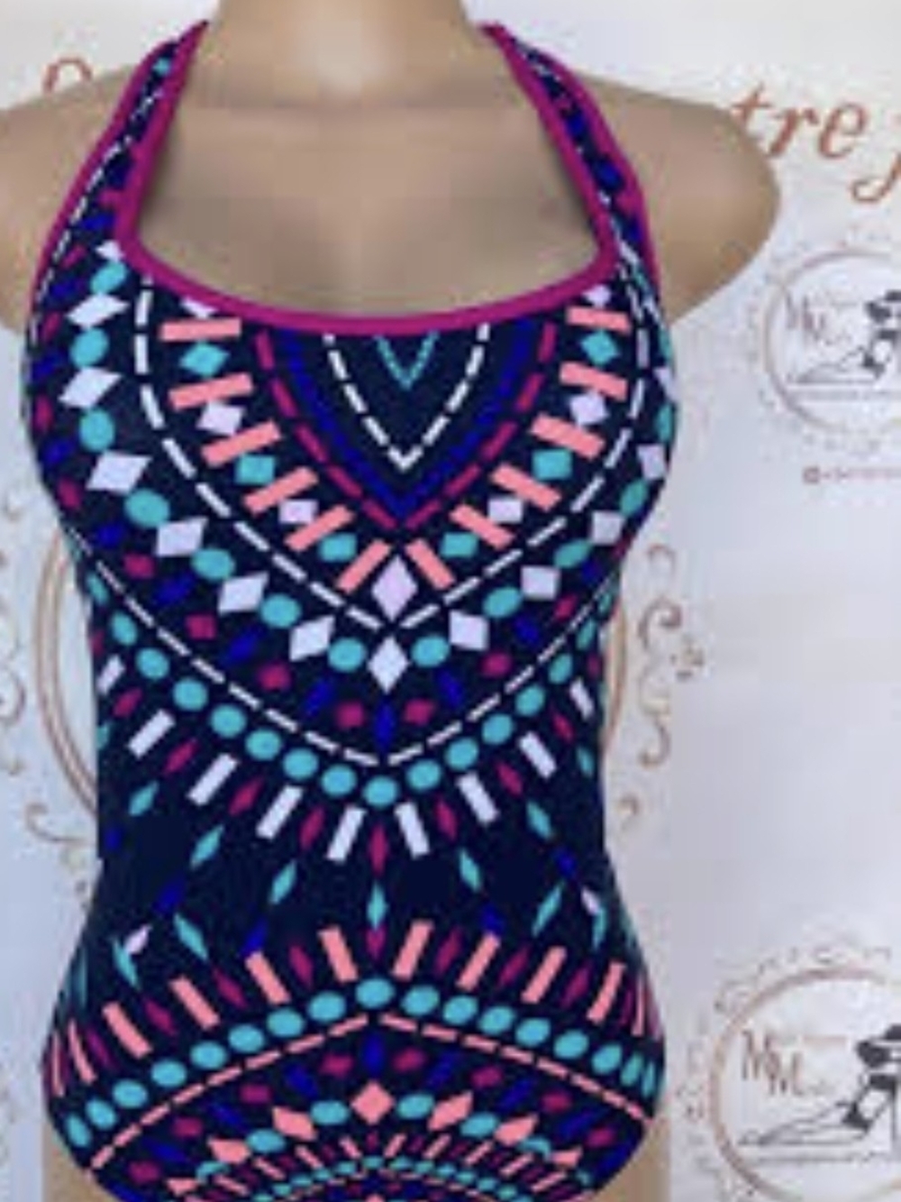 colorful one-piece swimsuit features a vibrant geometric aztec pattern